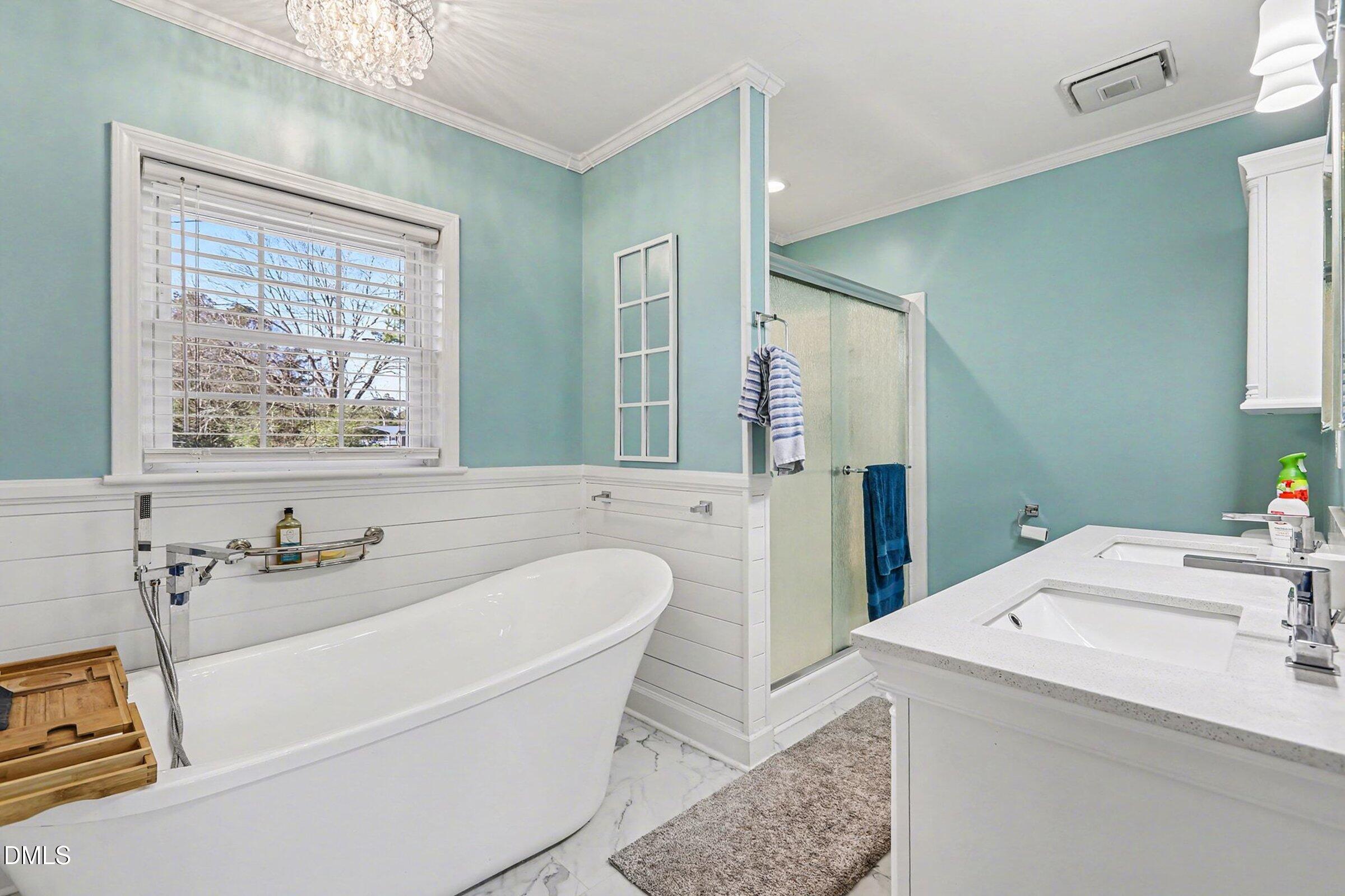 774 Abbott Road Henderson, NC 27537 - Photo 26 of 31 a bathroom with a tub sink and mirror