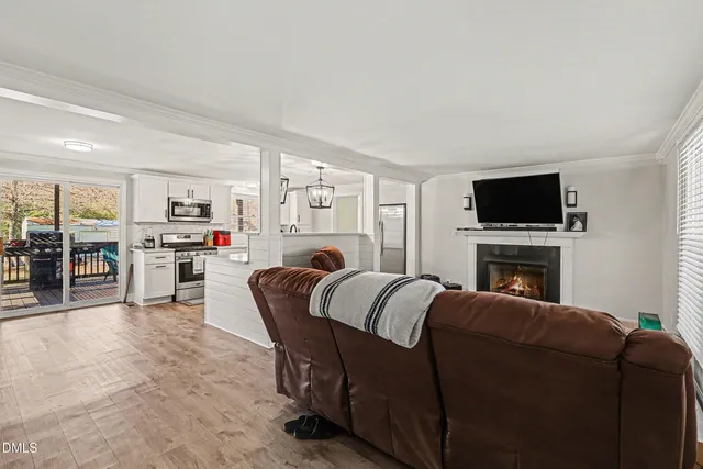 a living room with furniture a fireplace and a flat screen tv