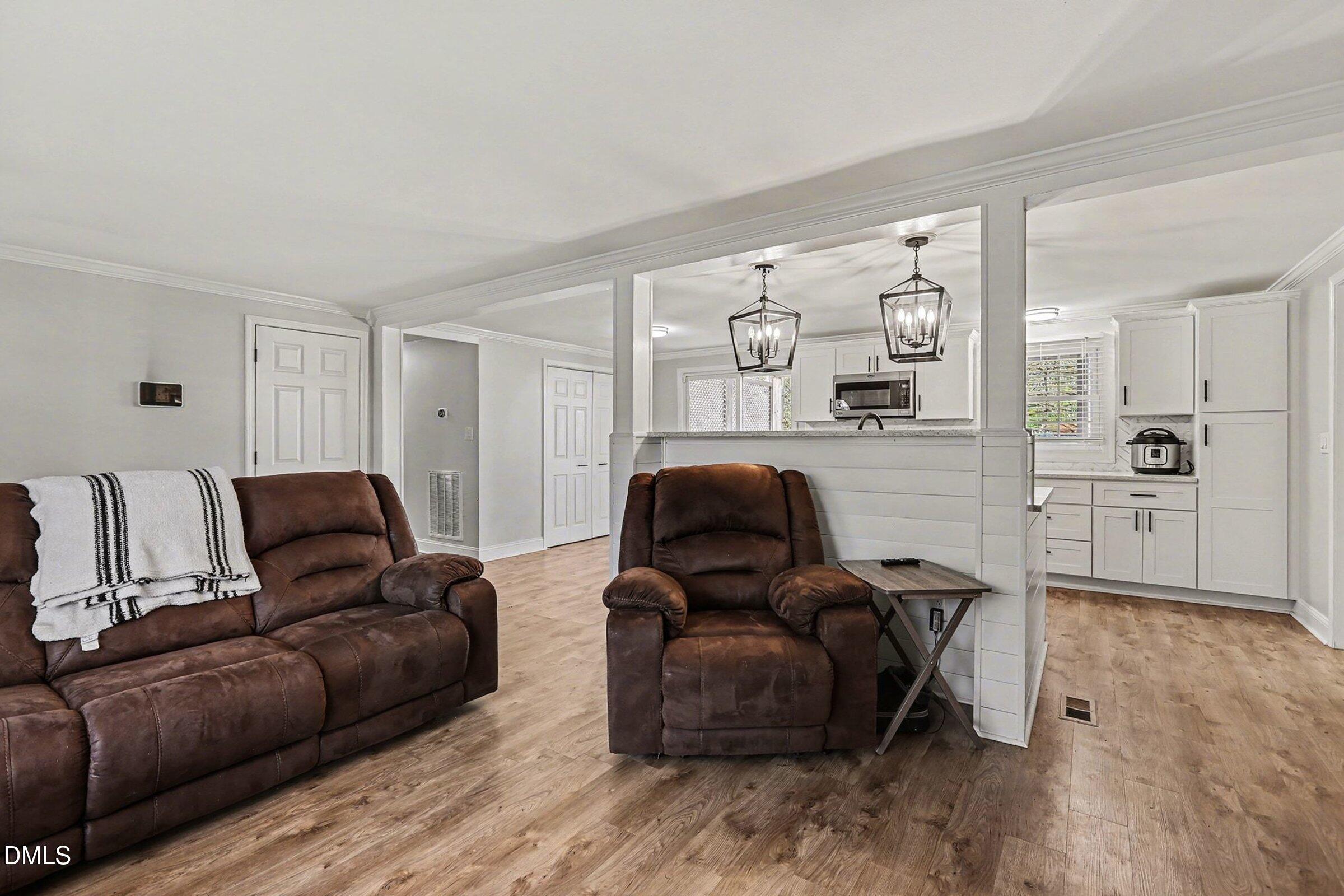 774 Abbott Road Henderson, NC 27537 - Photo 6 of 31 a living room with furniture and a flat screen tv