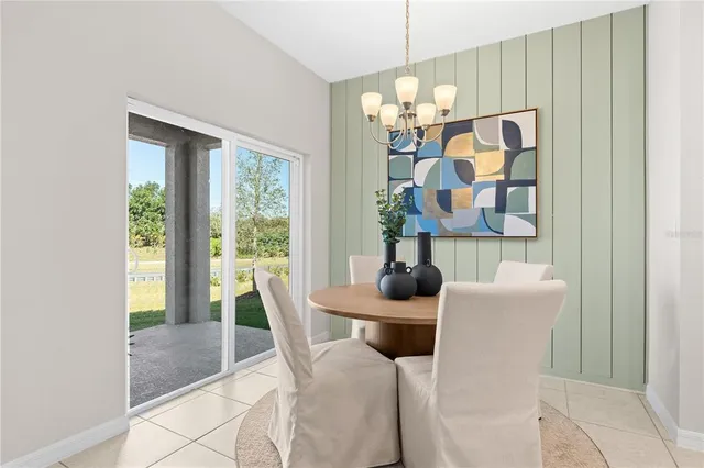 a dining room with furniture and chandelier kitchen view