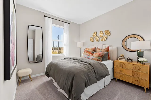 a bedroom with bed and a two mirror