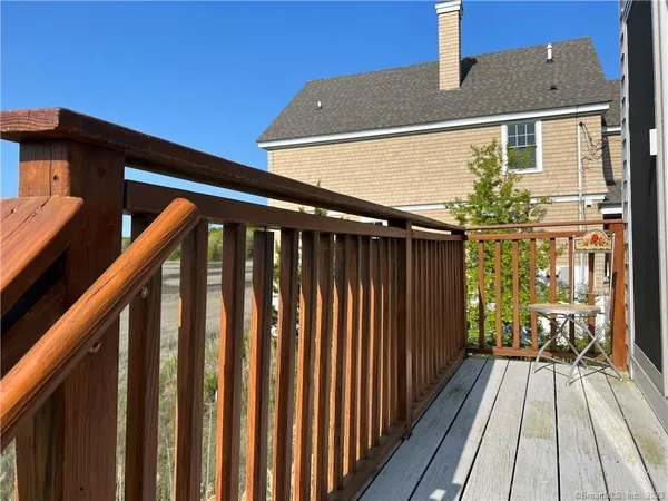a view of wooden balcony with wooden floor and fence