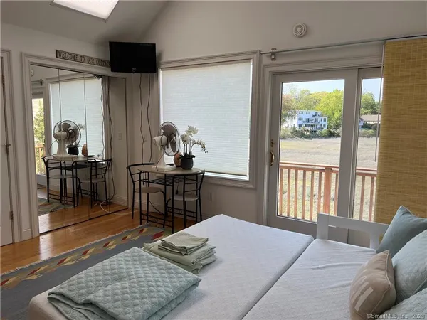 a bedroom with furniture and a window