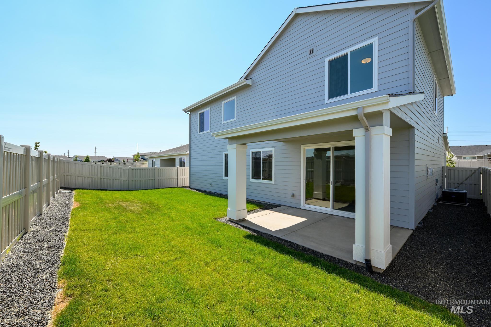14854 Brown Pelican Street Caldwell, ID 83607 - Photo 11 of 11 Back of house with a patio area and a fenced backyard