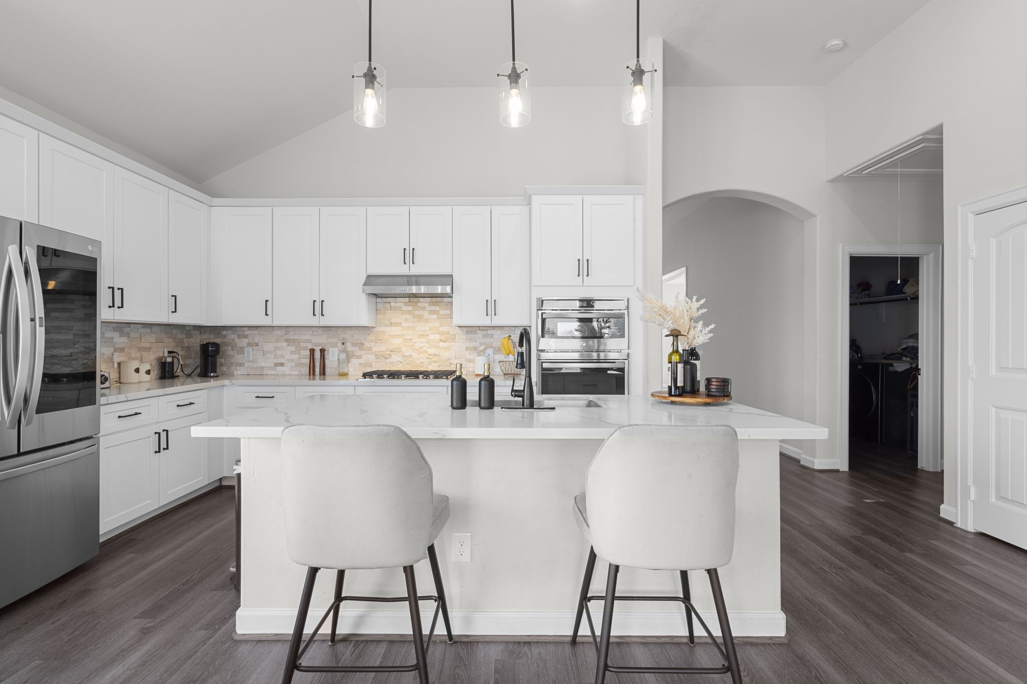 1294 County Road 5100 Cleveland, TX 77327 - Photo 11 of 27 Open-concept kitchen designed for both everyday living and effortless entertaining. The expansive center island offers generous prep space and seating, while crisp white cabinetry and modern lighting create a clean, timeless look filled with natural light.