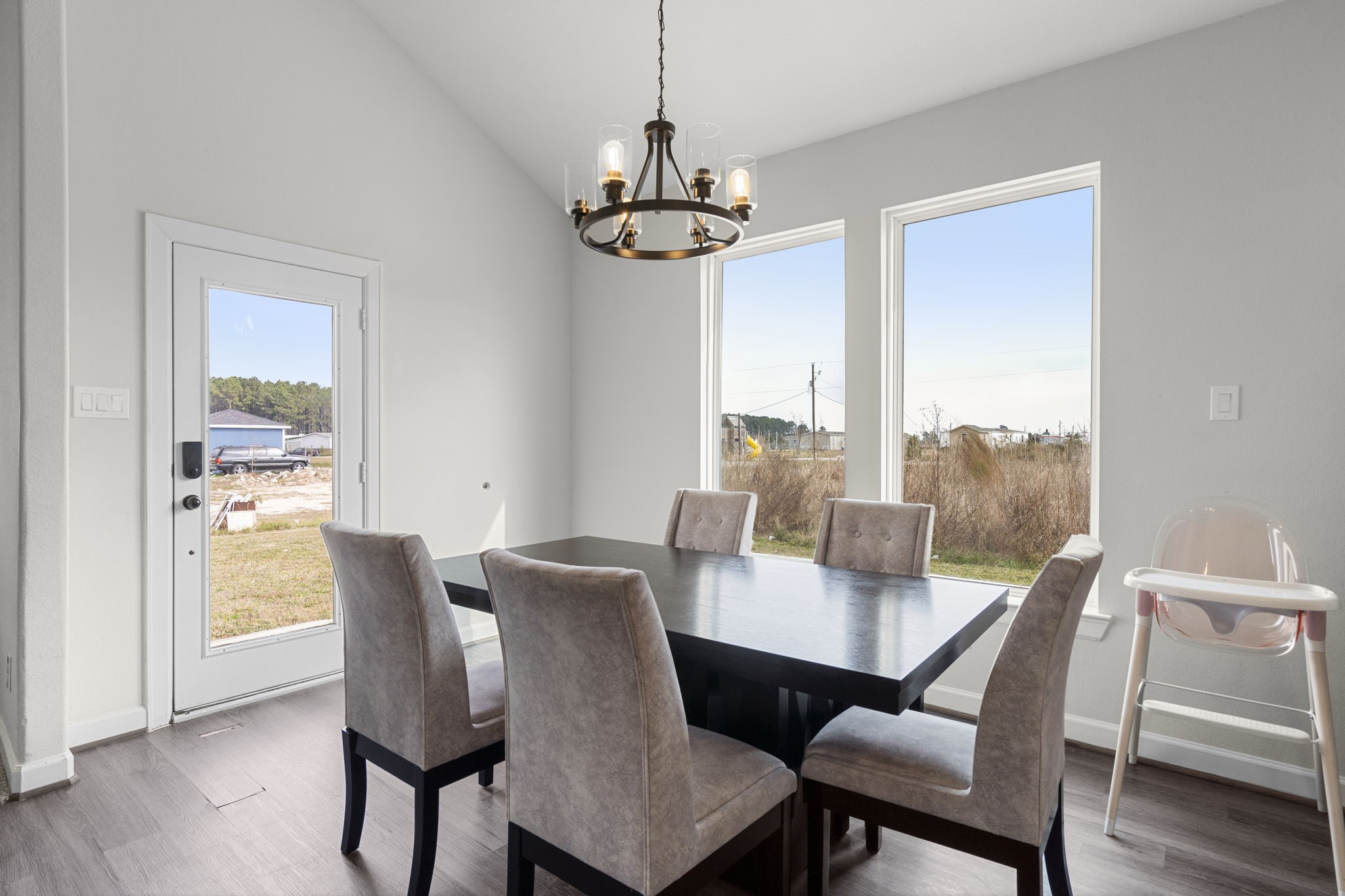 1294 County Road 5100 Cleveland, TX 77327 - Photo 12 of 27 A light-filled dining space framed by expansive windows that bring the outdoors in.