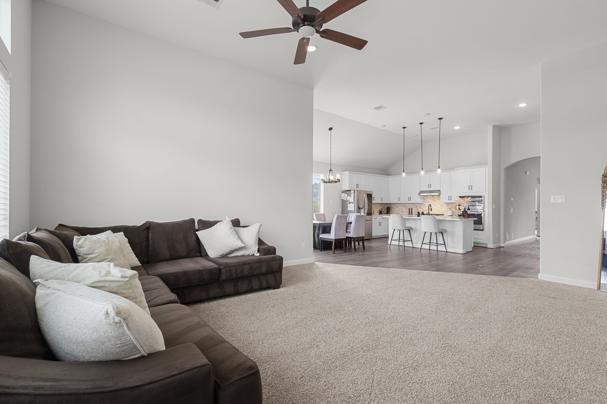 1294 County Road 5100 Cleveland, TX 77327 - Photo 15 of 27 The open layout and cozy seating arrangement make it an ideal place to unwind, with high ceilings and ceiling fan.