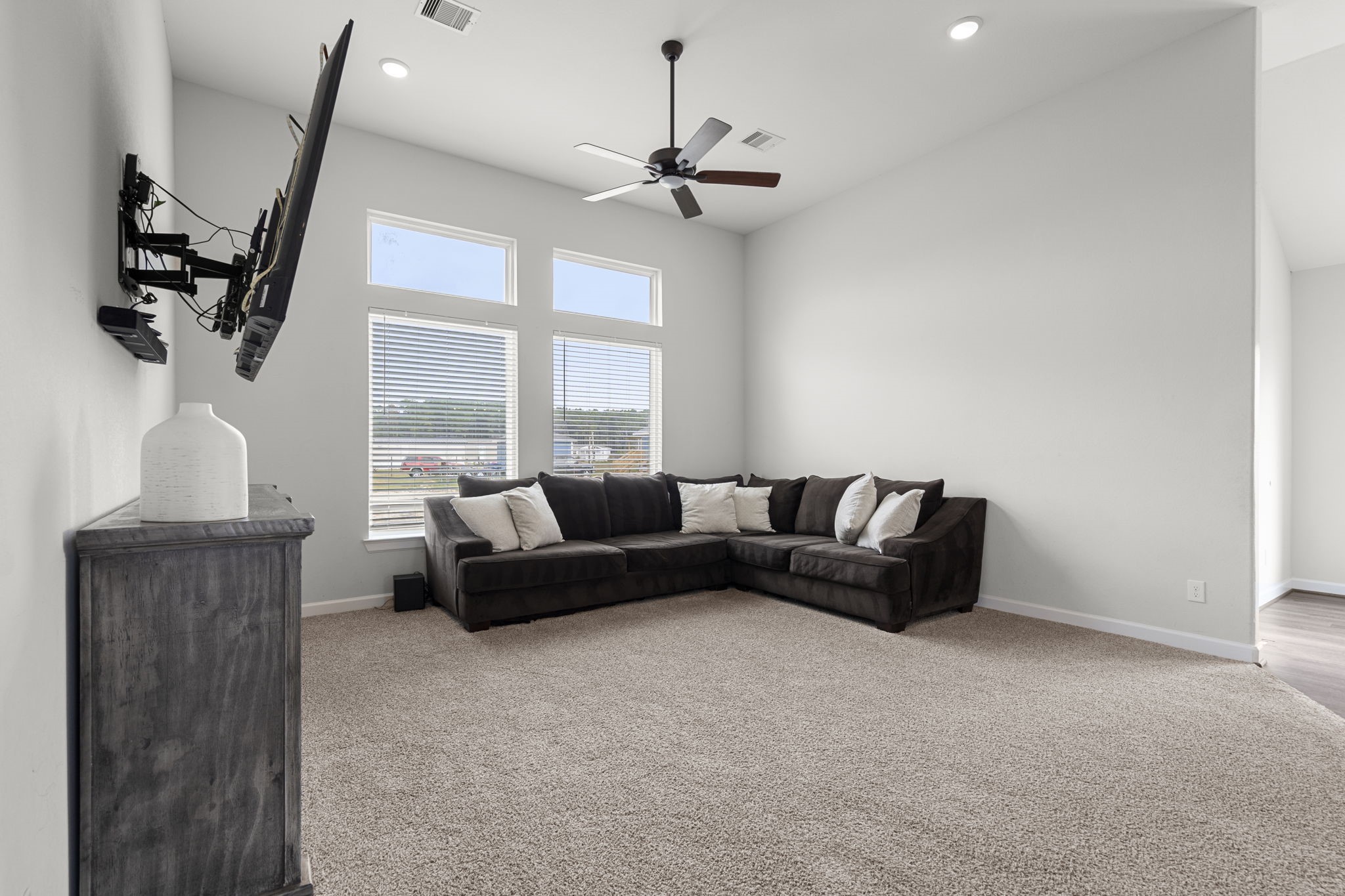 1294 County Road 5100 Cleveland, TX 77327 - Photo 16 of 27 Sun-filled and inviting, this living room features oversized windows that flood the space with natural light.