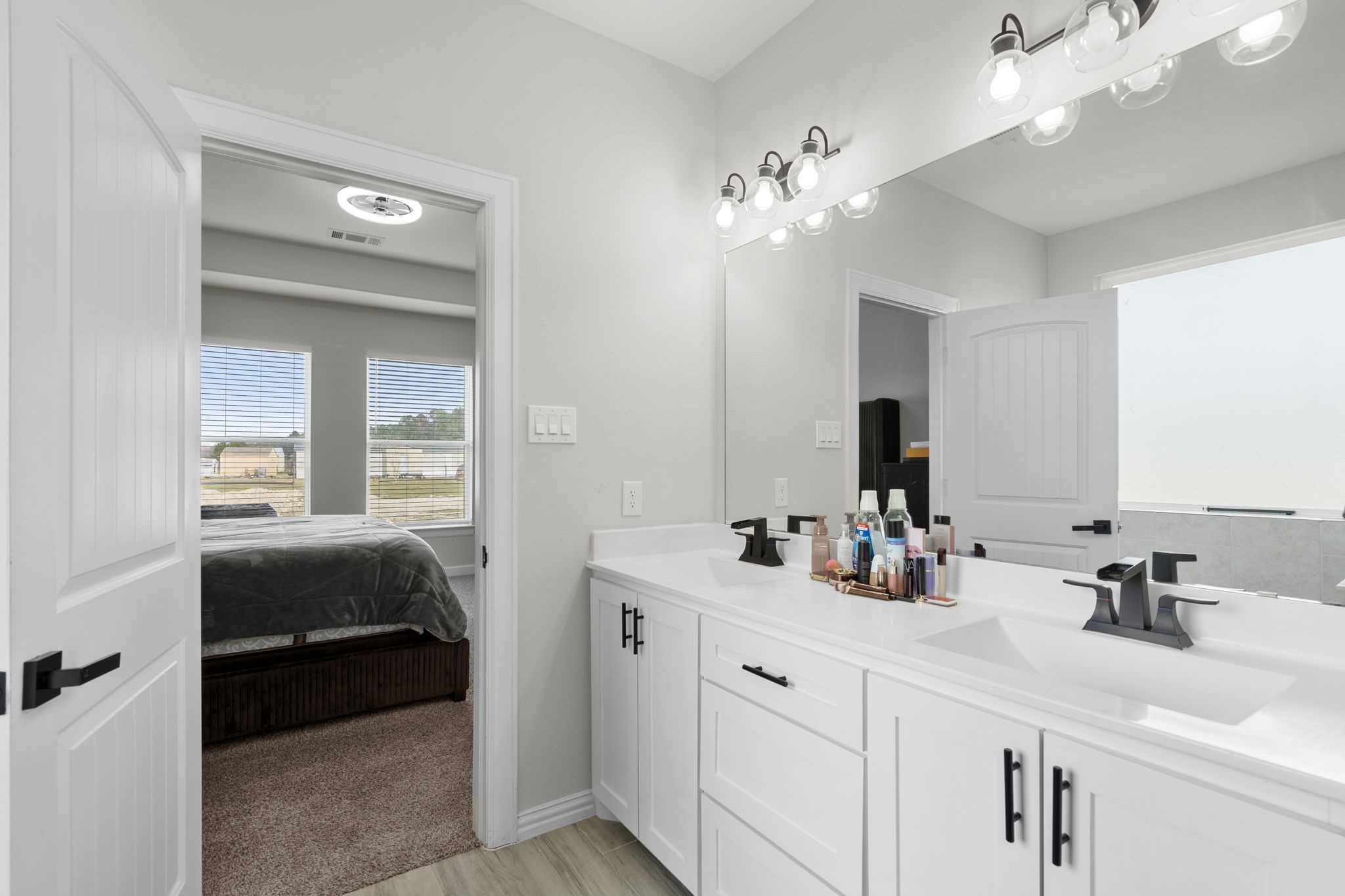 1294 County Road 5100 Cleveland, TX 77327 - Photo 19 of 27 Featuring a large vanity, abundant counter space, and natural light.