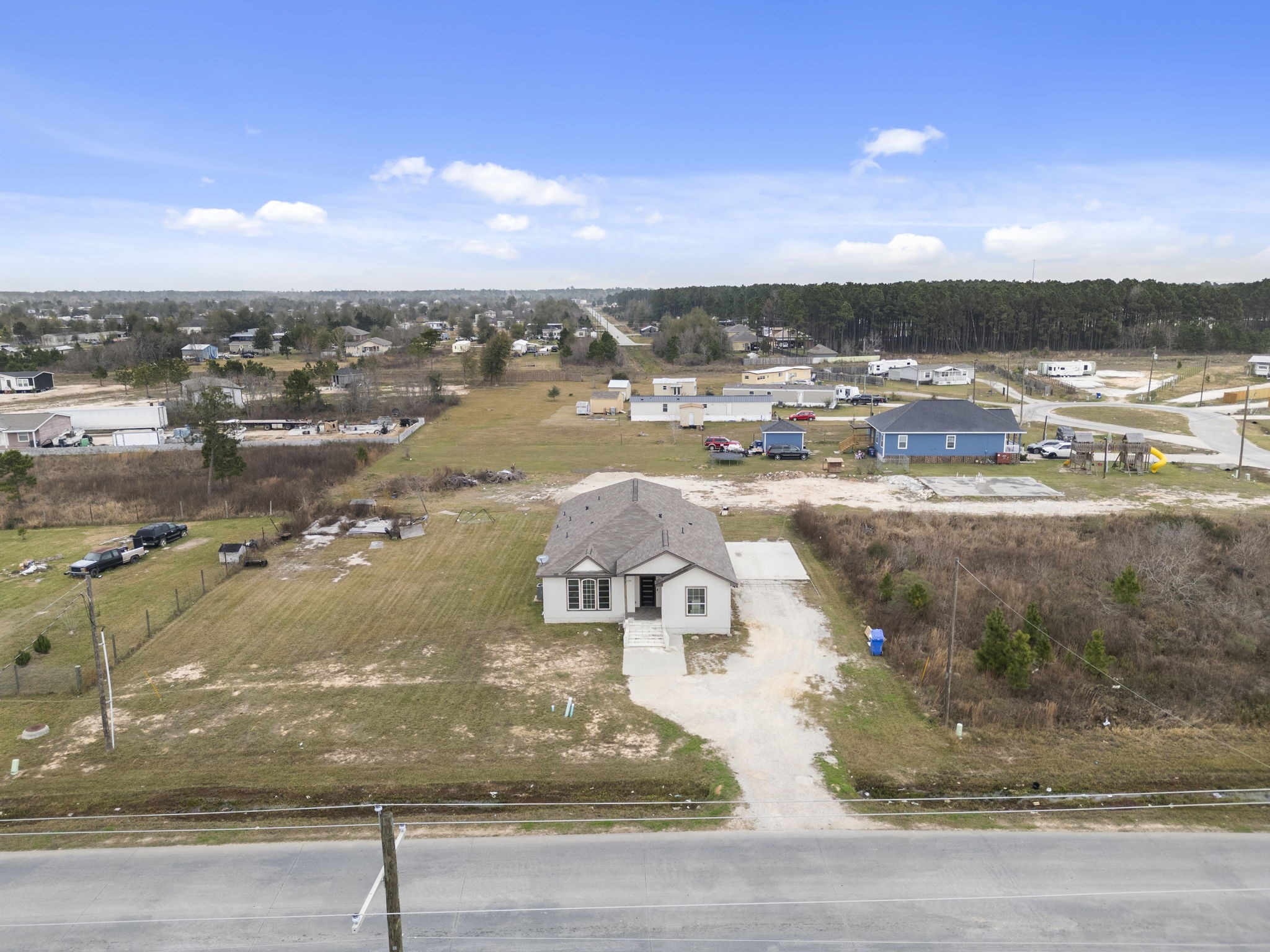 1294 County Road 5100 Cleveland, TX 77327 - Photo 2 of 27 The home’s position within the surrounding area, including nearby roads, neighboring homes, and general land use.