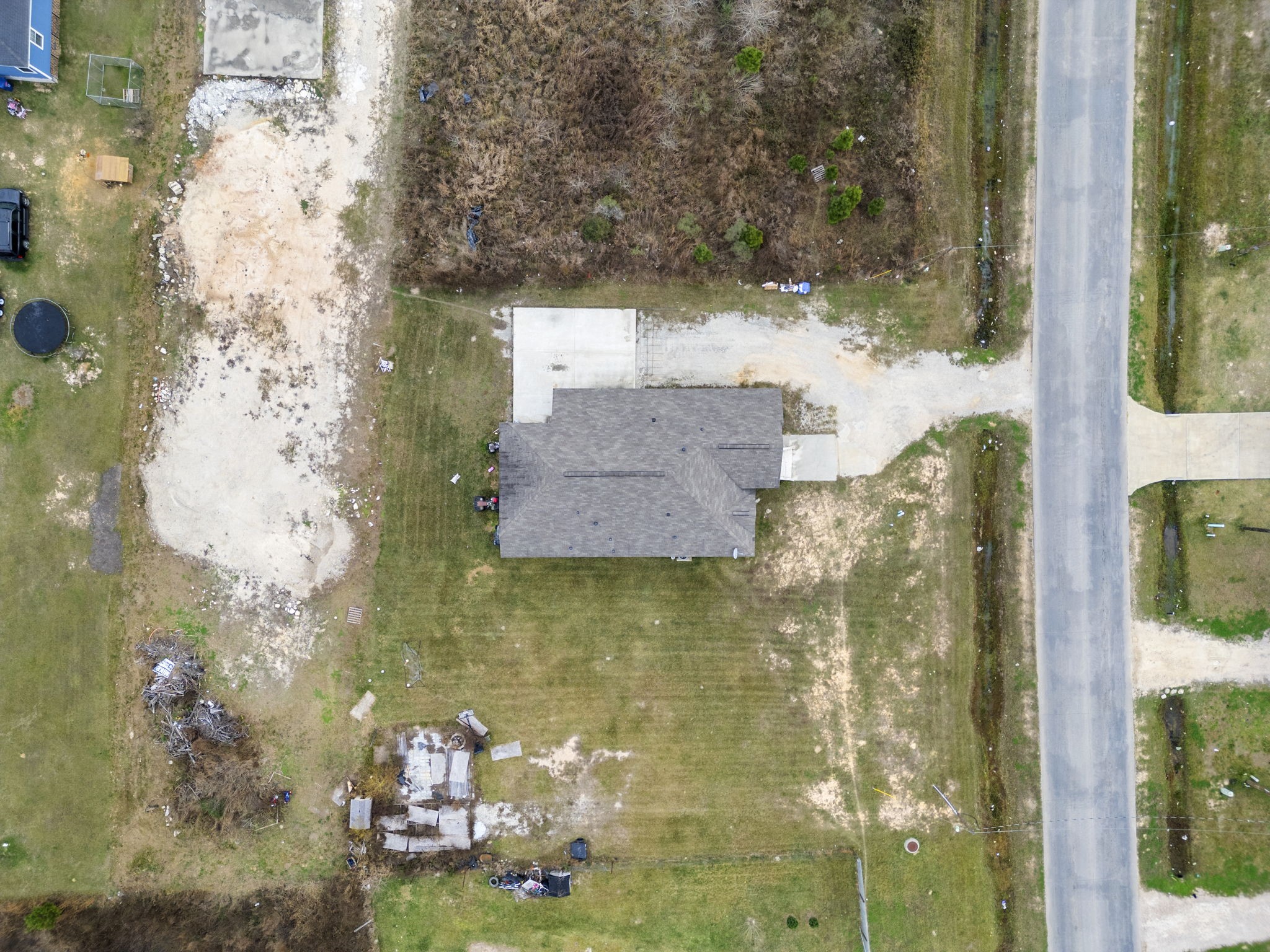 1294 County Road 5100 Cleveland, TX 77327 - Photo 3 of 27 Overhead perspective highlighting the home’s footprint on the lot, driveway placement, and distance to the roadway.