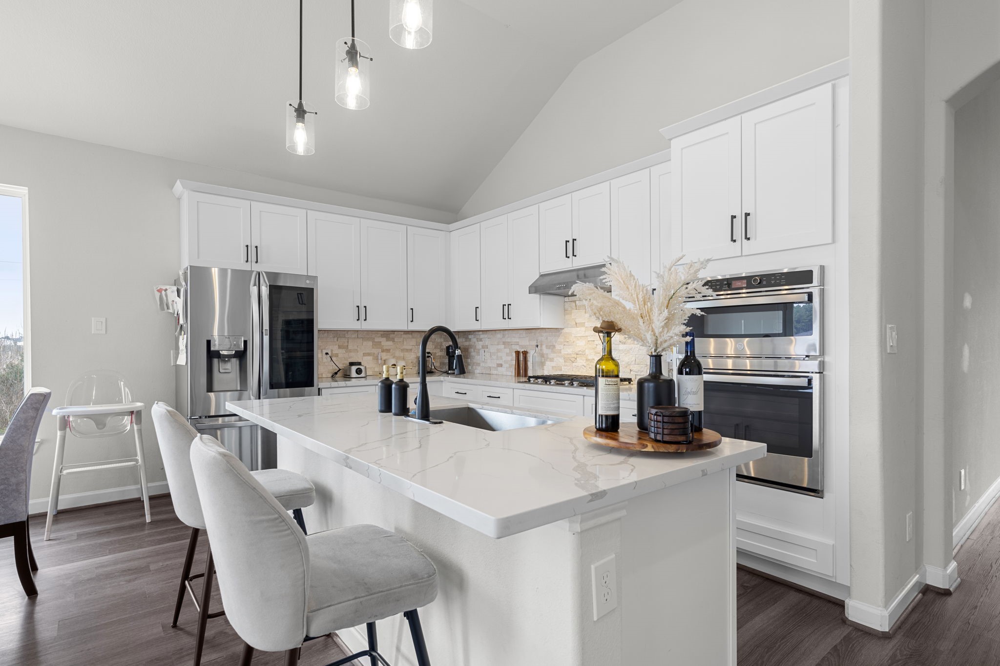 1294 County Road 5100 Cleveland, TX 77327 - Photo 10 of 27 Designed with hosting in mind, this kitchen offers plenty of seating at the oversized island, paired with high-end finishes and contemporary touches.