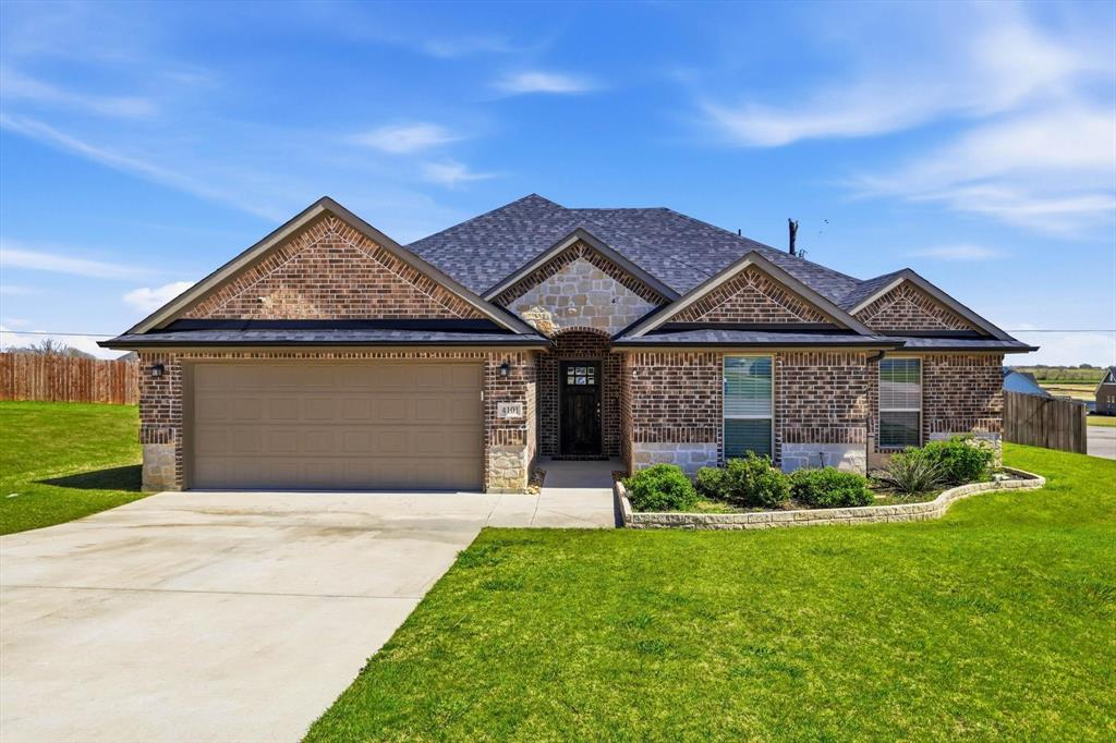 4101 Windmill Court Sanger, TX 76266 - Photo 1 of 36 a front view of a house with a yard and garage