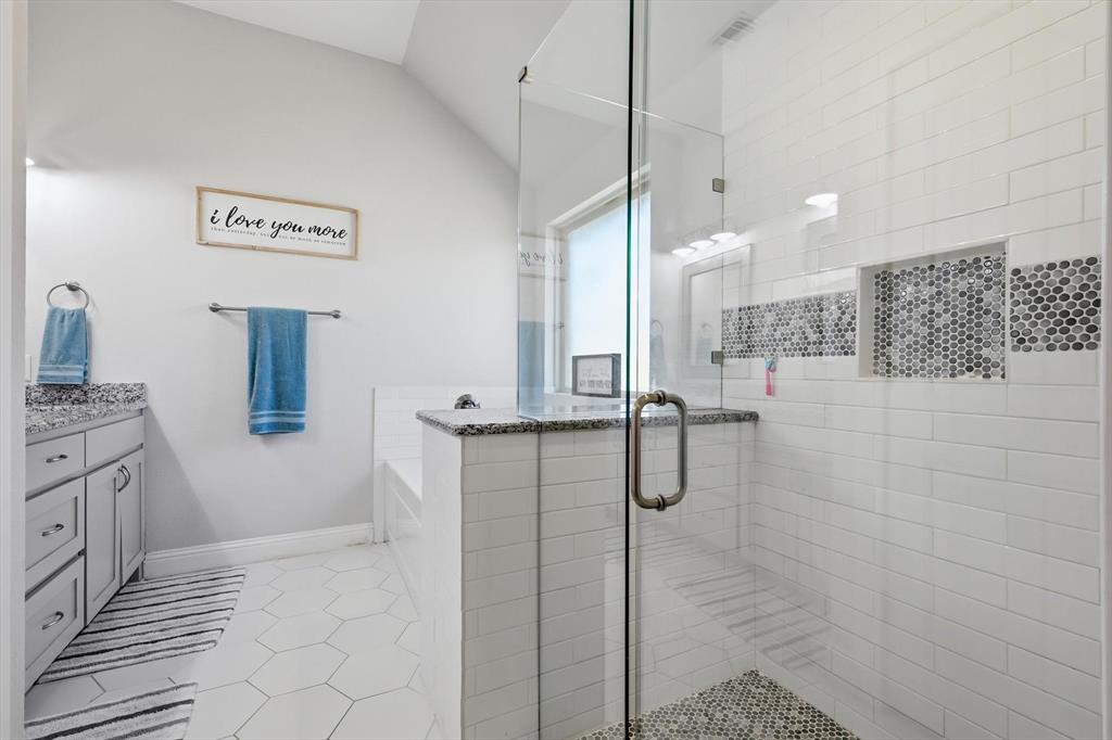 4101 Windmill Court Sanger, TX 76266 - Photo 21 of 36 a bathroom with a granite countertop sink a toilet and shower
