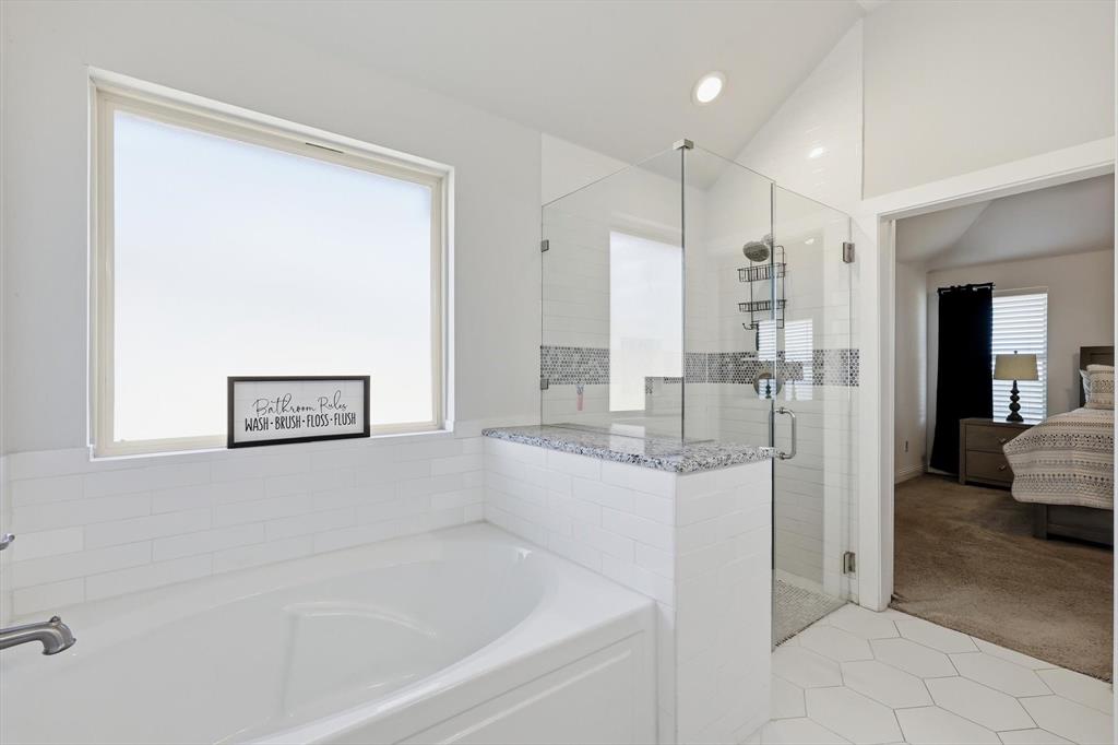 4101 Windmill Court Sanger, TX 76266 - Photo 22 of 36 a bathroom with a bathtub and a shower