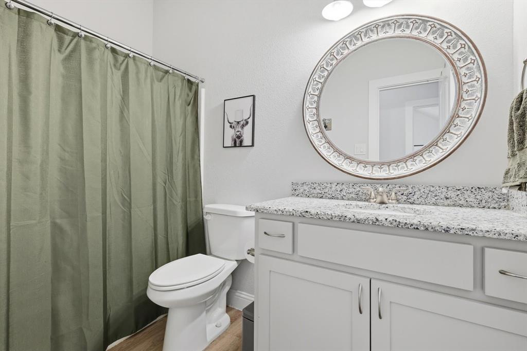4101 Windmill Court Sanger, TX 76266 - Photo 25 of 36 a bathroom with a toilet and a sink
