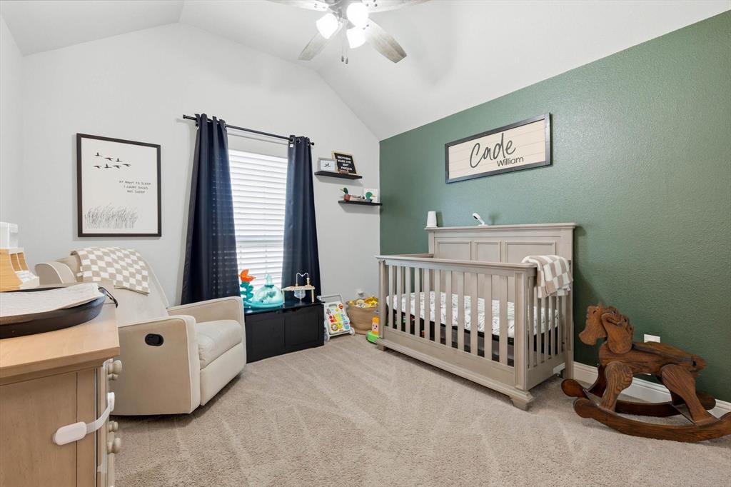 4101 Windmill Court Sanger, TX 76266 - Photo 26 of 36 a bedroom with a bed and a chandelier