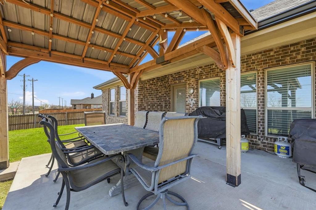 4101 Windmill Court Sanger, TX 76266 - Photo 31 of 36 a view of a patio with a table and chairs