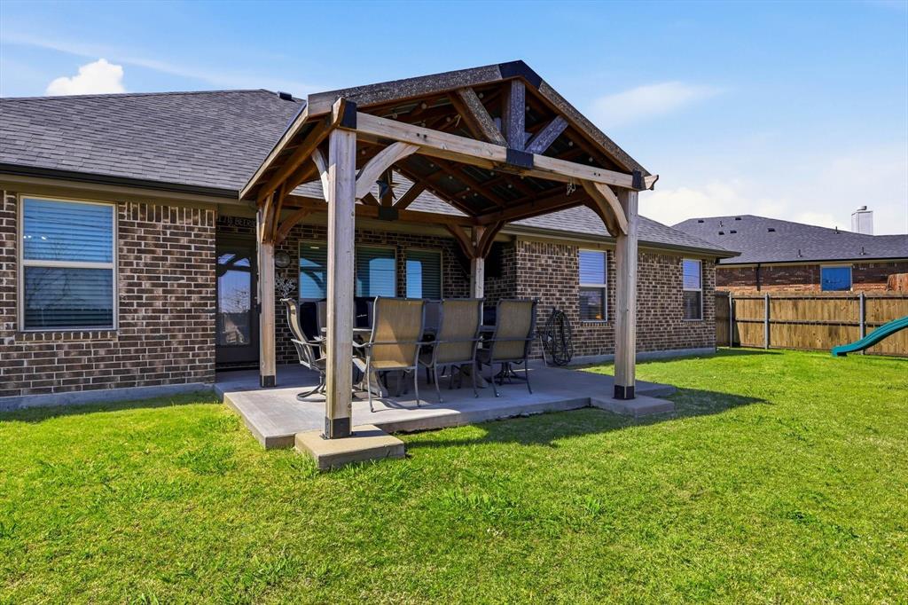 4101 Windmill Court Sanger, TX 76266 - Photo 36 of 36 a front view of a house with garden and sitting area