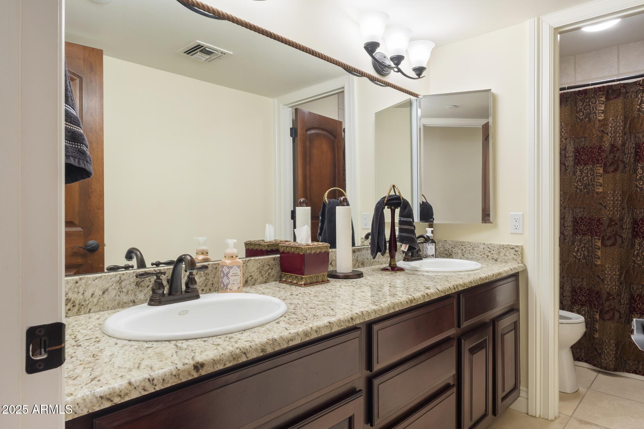 229 West Vista Avenue Phoenix, AZ 85021 - Photo 51 of 115 a bathroom with a granite countertop sink and a mirror