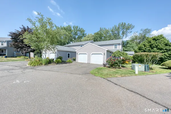 a front view of a house with a yard and a garage