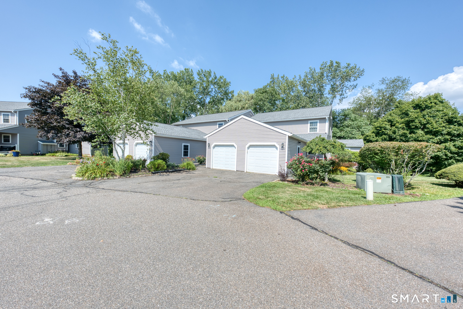 a front view of a house with a yard and a garage