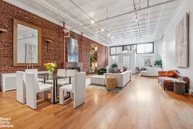 a view of a livingroom with furniture and staircase