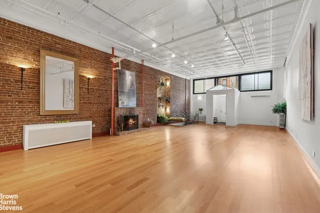 a view of a livingroom with furniture and a fireplace