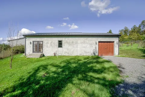 a kitchen with a stove a sink and a wooden floor