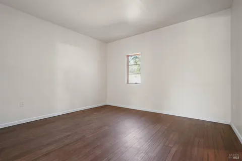 a green field with some trees in the background