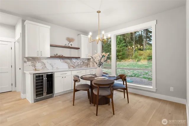 a view of a kitchen with a table and chairs