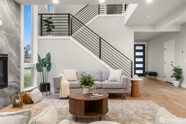 a living room with furniture potted plant and a window