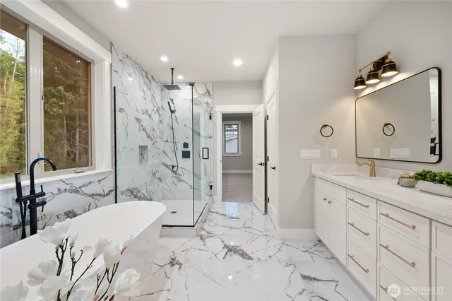 a bathroom with a tub sink and mirror