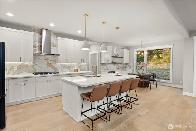 a kitchen with stainless steel appliances kitchen island granite countertop a sink and cabinets
