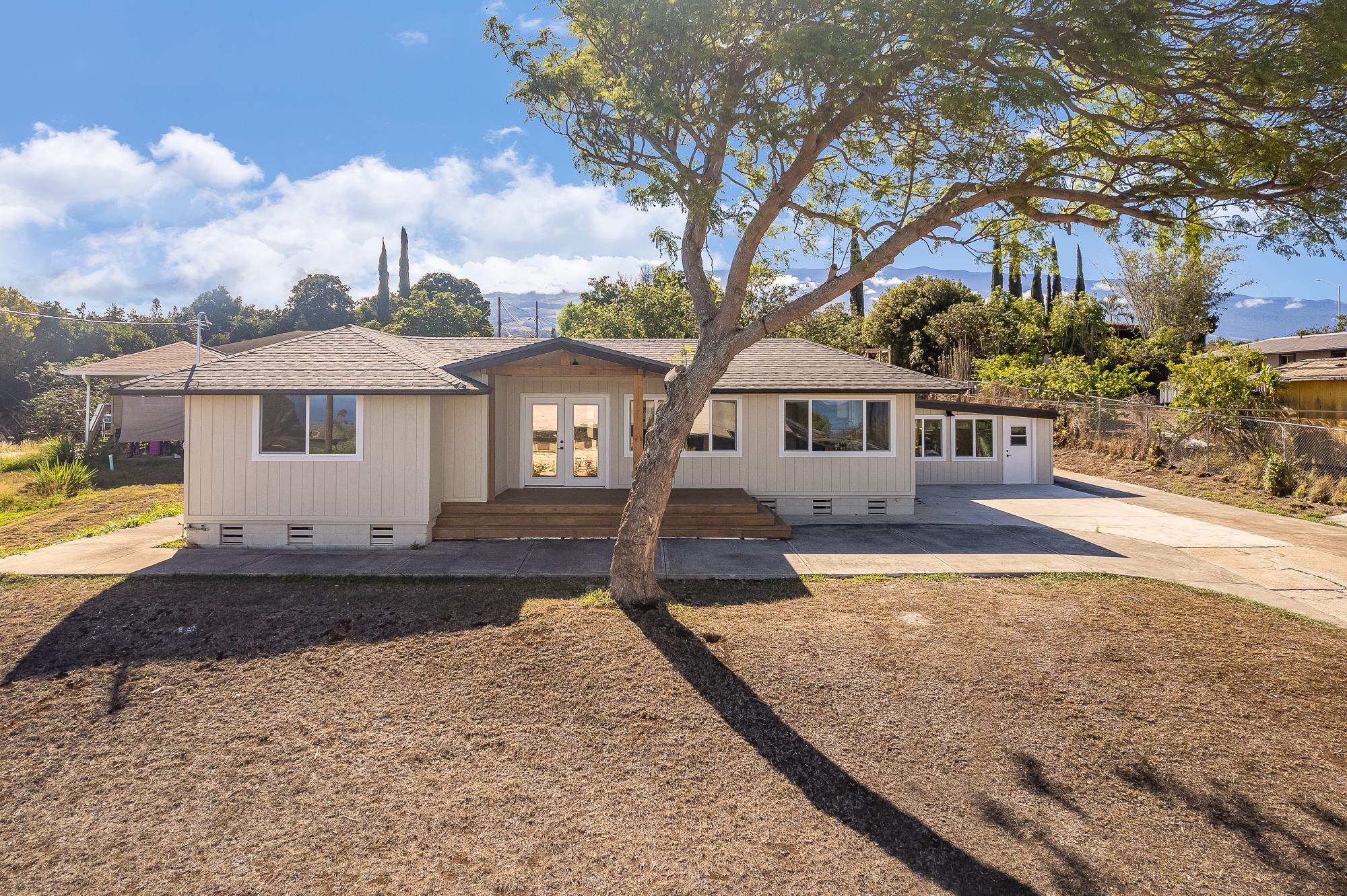 37 Alohi Place, Unit A Makawao, HI 96768 - Photo 1 of 1 a front view of a house with a yard and garage