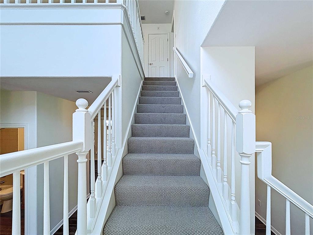 4103 North Rye Road Parrish, FL 34219 - Photo 21 of 40 a view of staircase with lots of frames on wall and wooden floor