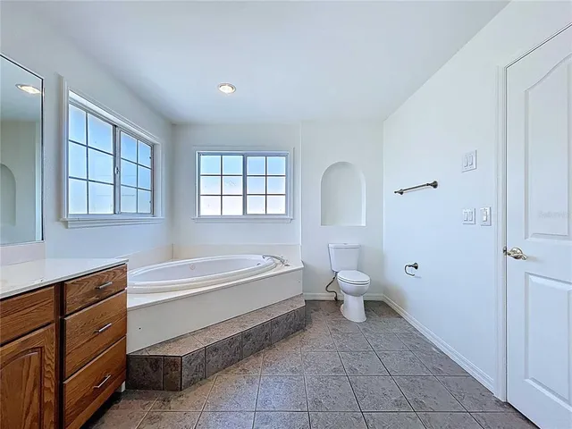 a utility room with stainless steel appliances cabinets and a sink