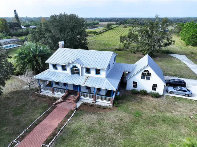 an aerial view of a house with outdoor space