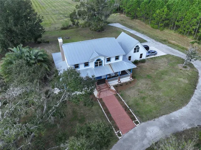 an aerial view of residential houses with outdoor space and street view