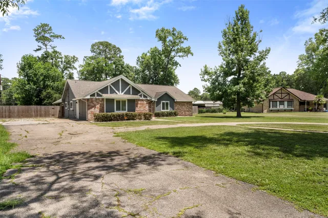 a view of house with garden space and trees