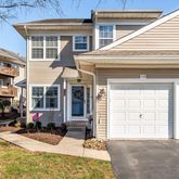 a view of a house with a barbeque and wooden stairs