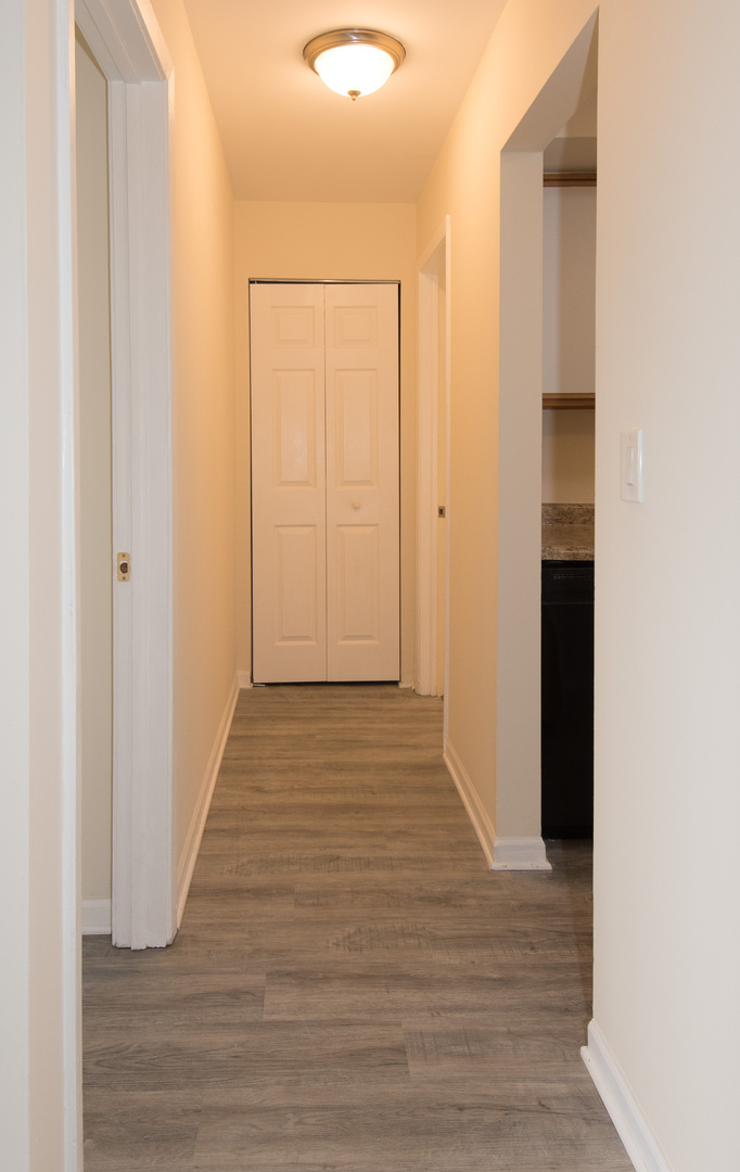 2218 South Goebbert Road, Unit 487 Arlington Heights, IL 60005 - Photo 11 of 23 a view of a hallway with wooden floor
