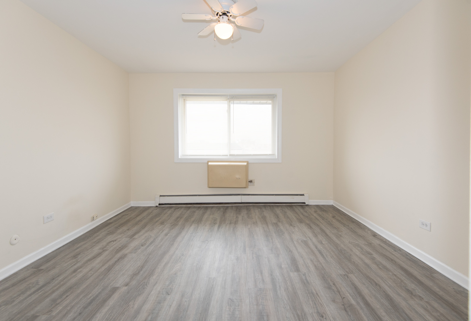 2218 South Goebbert Road, Unit 487 Arlington Heights, IL 60005 - Photo 12 of 23 an empty room with wooden floor and windows