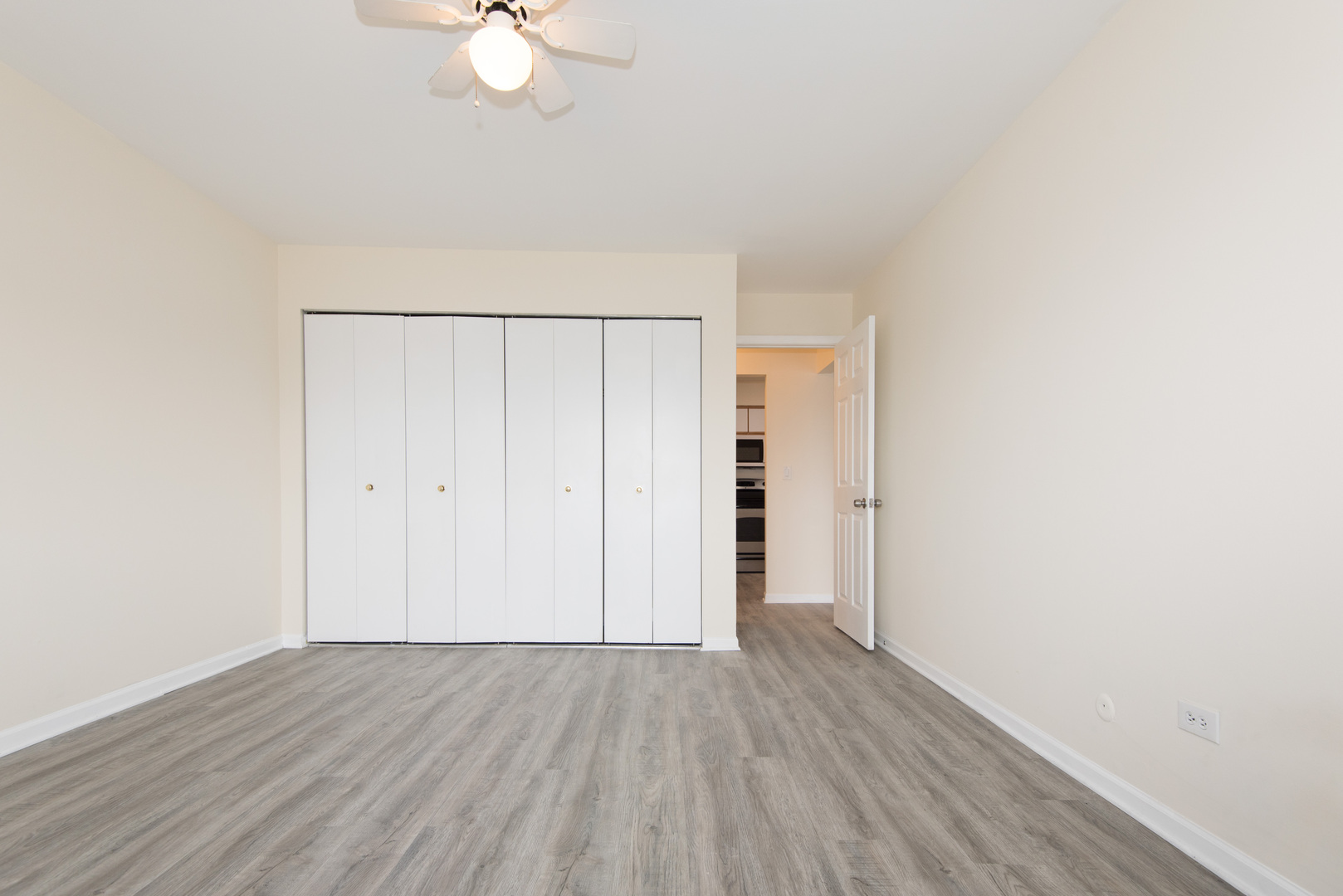 2218 South Goebbert Road, Unit 487 Arlington Heights, IL 60005 - Photo 13 of 23 a view of an empty room with wooden floor