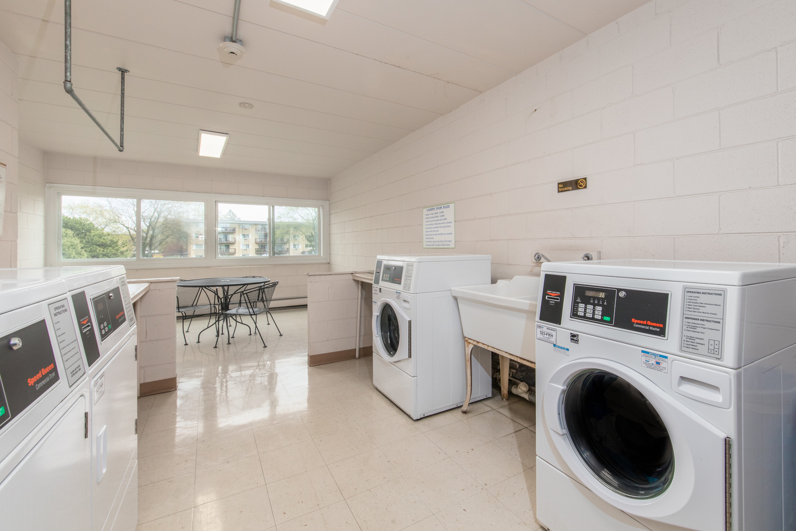 2218 South Goebbert Road, Unit 487 Arlington Heights, IL 60005 - Photo 18 of 23 a utility room with dryer washer and a view of living room
