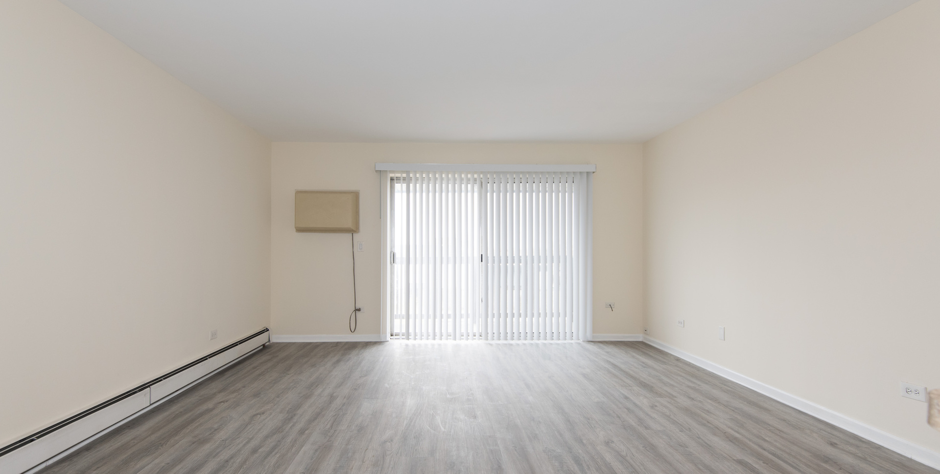 2218 South Goebbert Road, Unit 487 Arlington Heights, IL 60005 - Photo 3 of 23 an empty room with wooden floor and windows