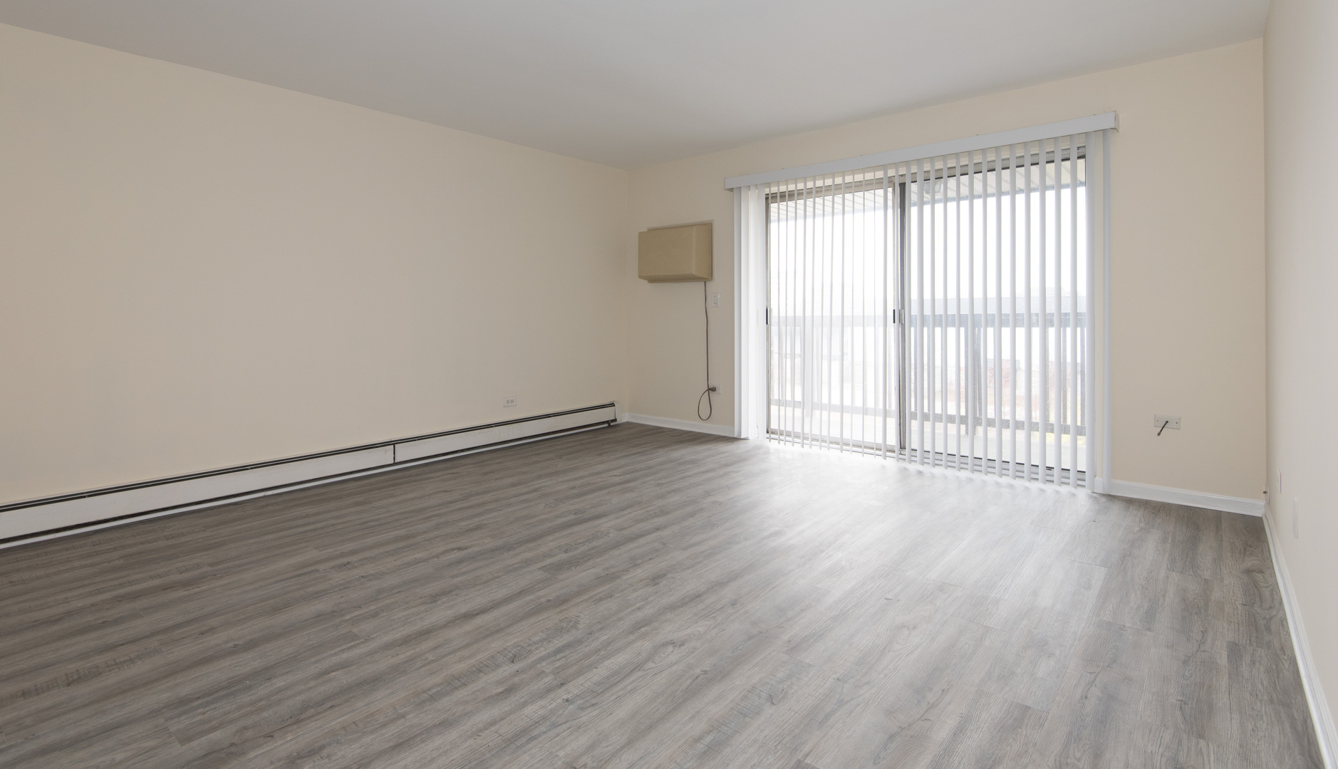 2218 South Goebbert Road, Unit 487 Arlington Heights, IL 60005 - Photo 4 of 23 wooden floor in an empty room with a window