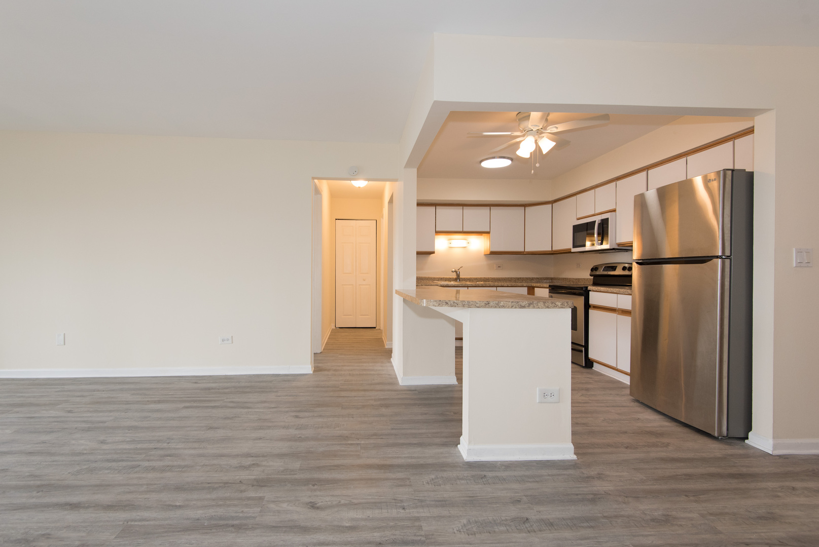 2218 South Goebbert Road, Unit 487 Arlington Heights, IL 60005 - Photo 7 of 23 a kitchen with white cabinets and stainless steel appliances