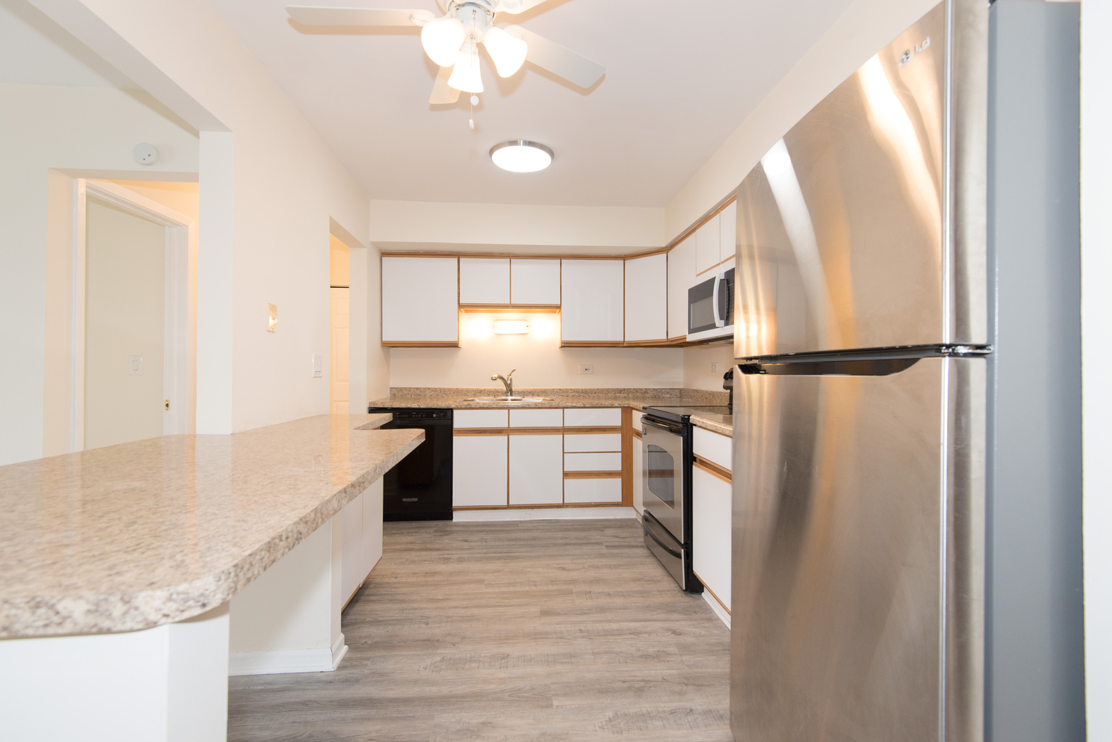 2218 South Goebbert Road, Unit 487 Arlington Heights, IL 60005 - Photo 8 of 23 a kitchen with a refrigerator a sink and dishwasher