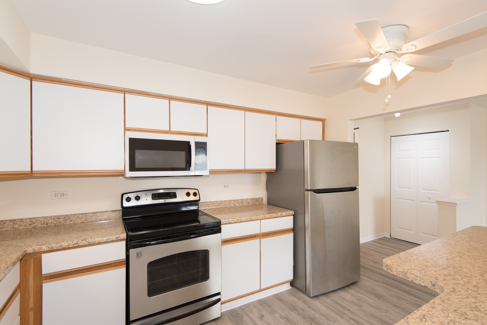2218 South Goebbert Road, Unit 487 Arlington Heights, IL 60005 - Photo 9 of 23 a kitchen with a refrigerator stove and microwave